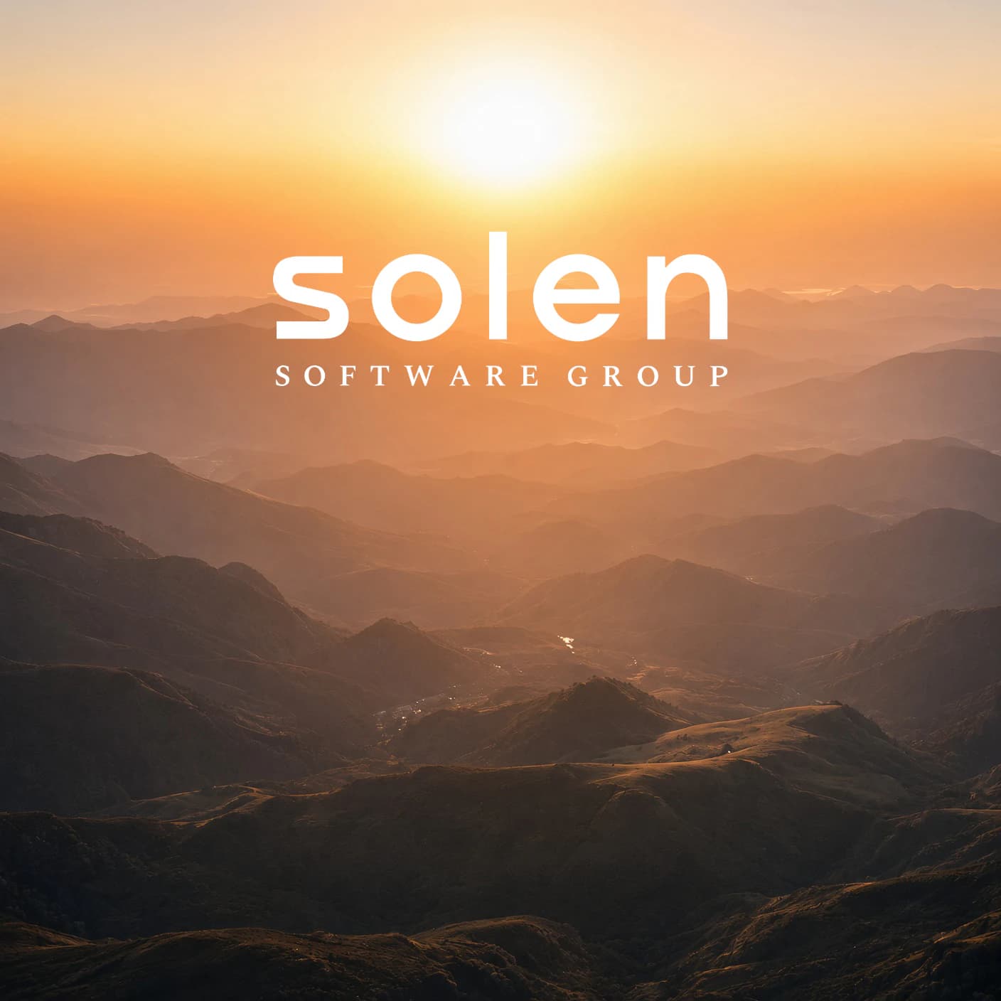 Sunrise over layered mountain ridges